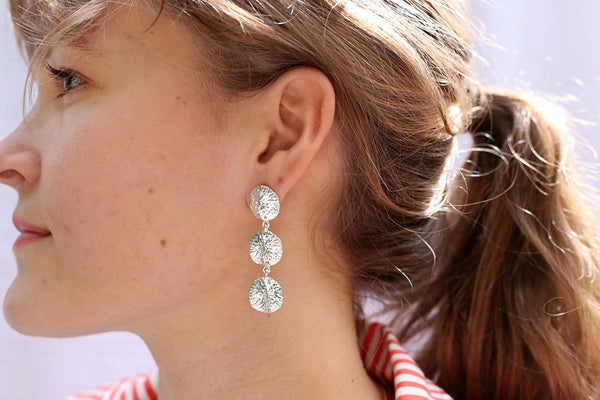 Girl wearing Triple drop alligator scute earrings in silver by Gogo Jewelry