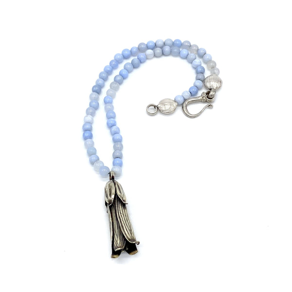trumpet vine pendant necklace alpaca on pale blue beads gogo jewelry