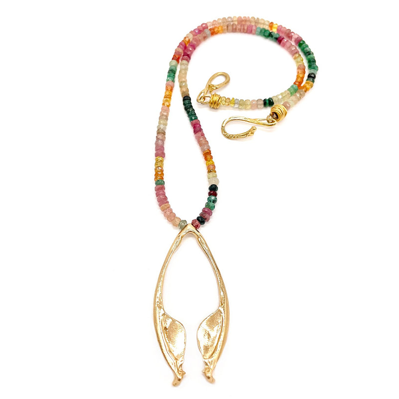 14k gold rattlesnake jawbone pendant on multi colored beads