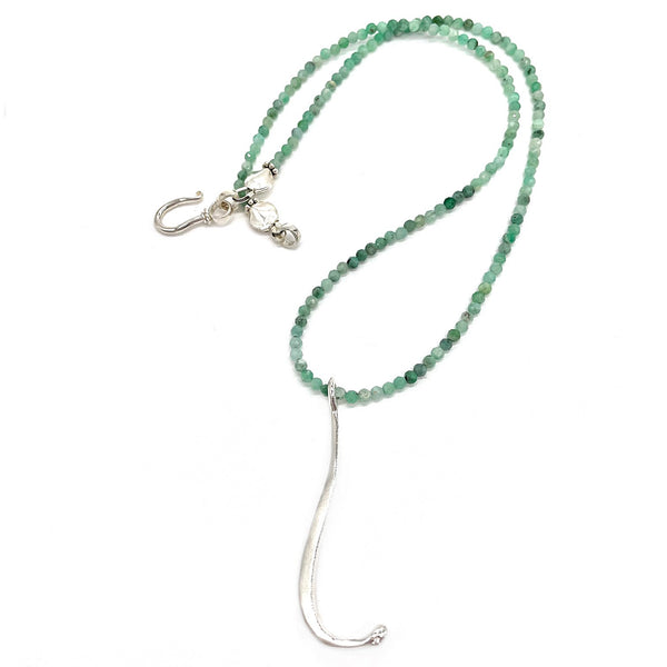 sterling silver raccoon pecker pendant on green beads