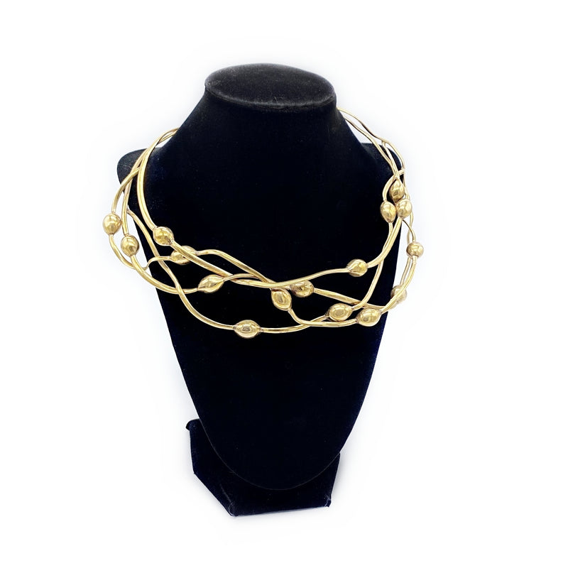 tumbaga seaweed necklace on black velvet stand 