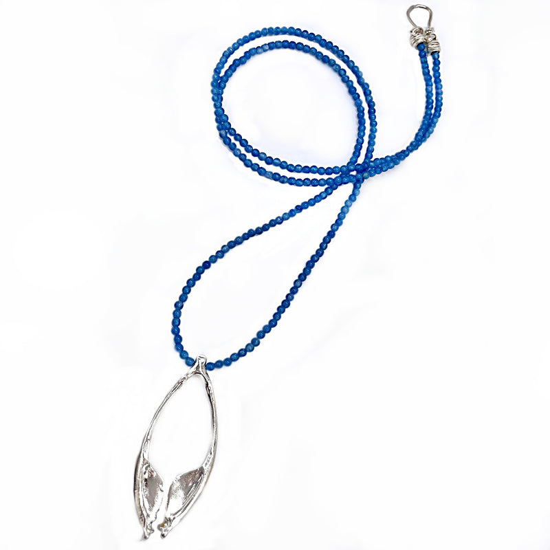 sterling silver rattlesnake jawbone pendant on dark blue beaded opera length necklace