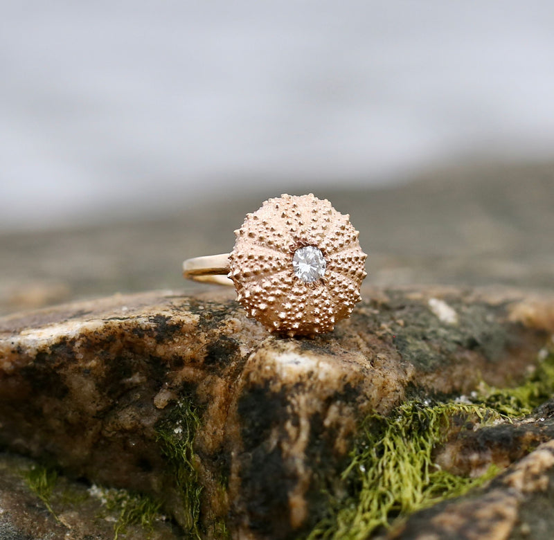 14k gold sea urchin ring with white diamond on mossy rock