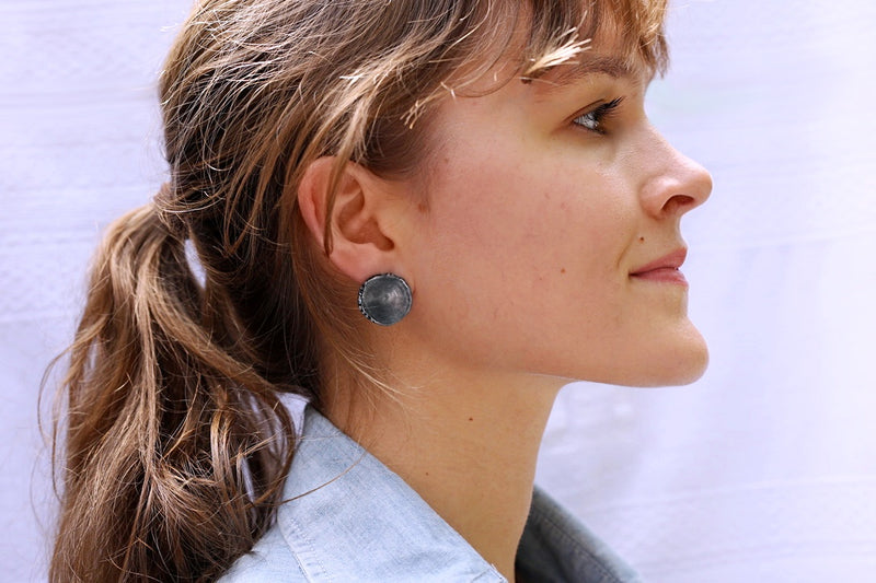 large sterling silver oxidized shark vertebrae earrings on brunette female model