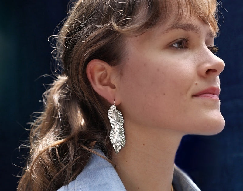 sterling silver sea oats earrings with wire on brunette female model