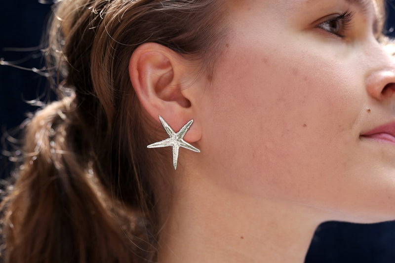 starfish earring sterling silver post on blonde female model gogo jewelry