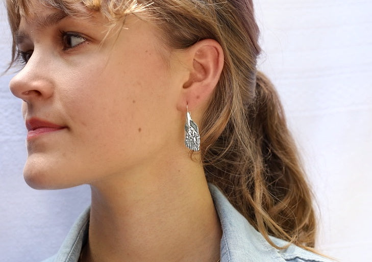 Female Model wearing silver garfish scale earring gogo jewelry
