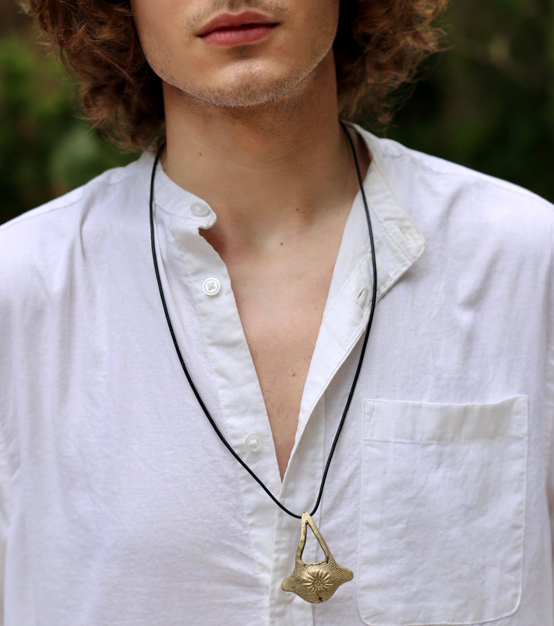 Male Model wearing Dolphin Vertebrae Necklace on black cord Gogo Jewelry