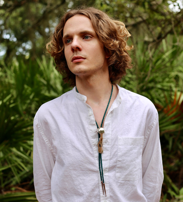 Male Model wearing Duck Skull Bolo tie in silver on Cumberland Island by Gogo Jewelry