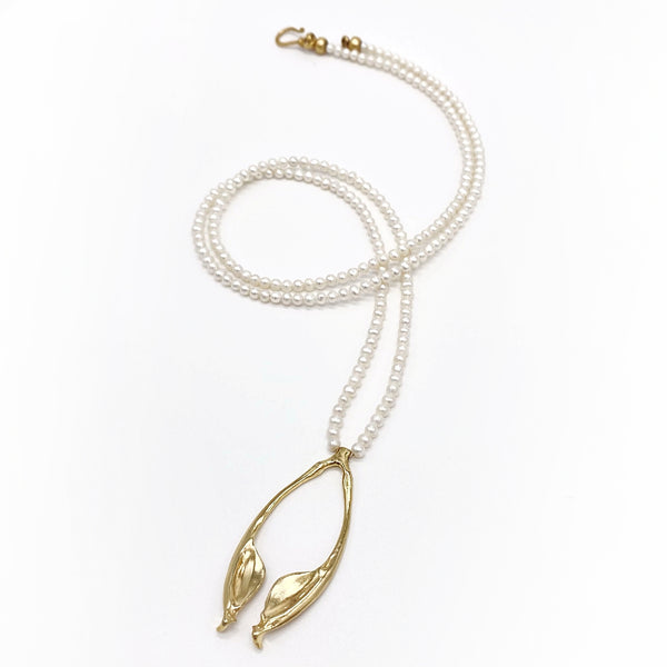 gold vermiel rattlesnake jawbone penant on opera length pearl strand