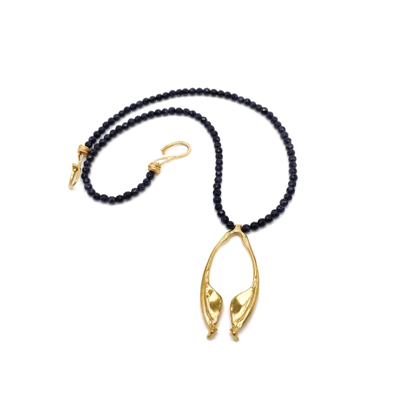 gold vermeil rattlesnake jawbone pendant on black beads