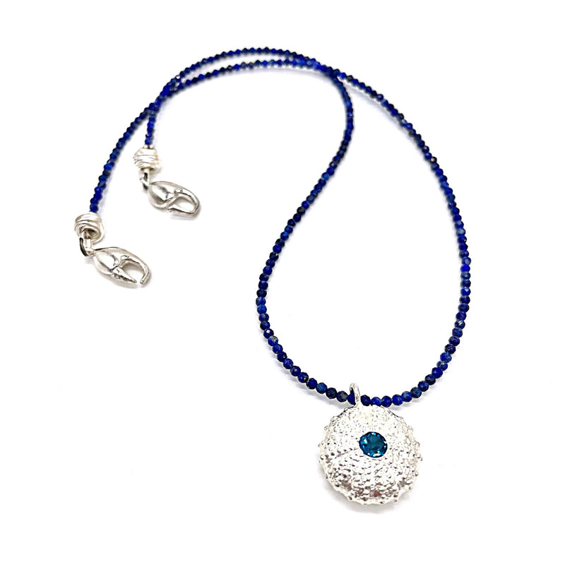 sterling silver sea urchin pendant with london blue topaz on dark blue beads
