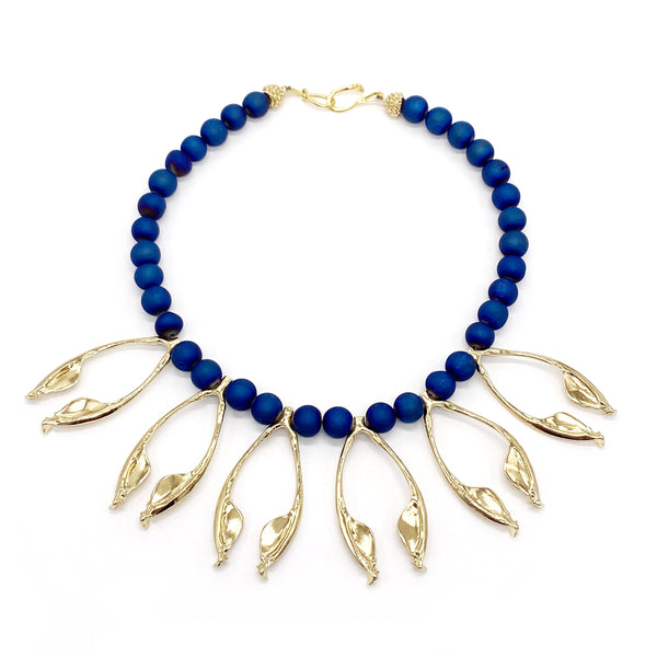 gold vermeil rattlesnake jawbone necklace top view on white background