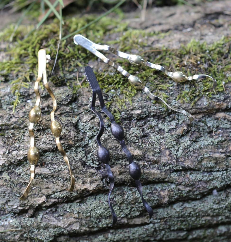 alpaca tumbaga and oxidized new england seaweed post earrings on log