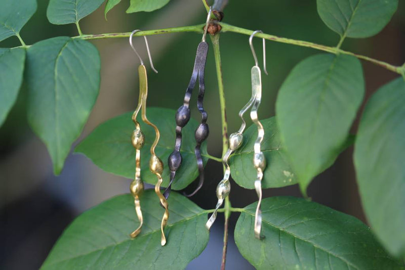 tumbaga oxidized and alpaca new england seaweed wire earrings hanging on vine