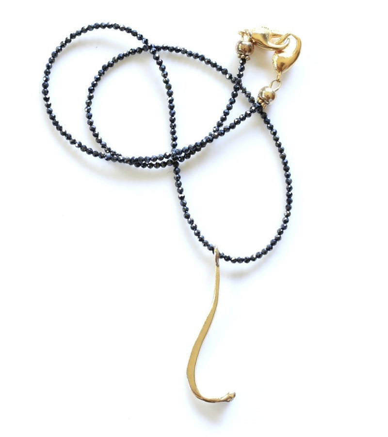 14k gold raccoon pecker pendant on black beads