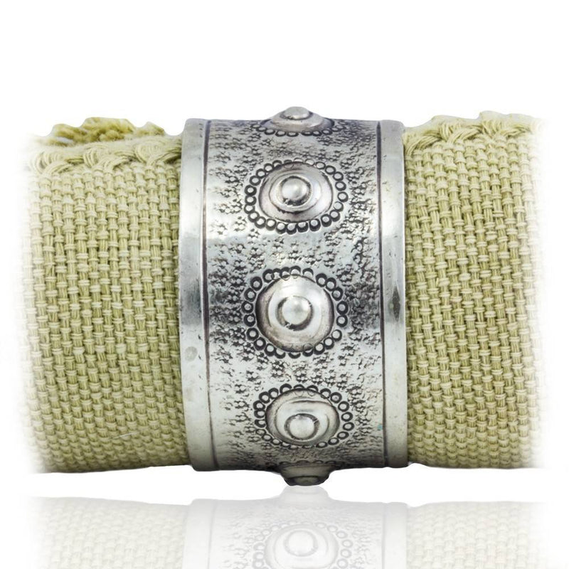 alpaca sea urchin napkin ring on green woven napkin