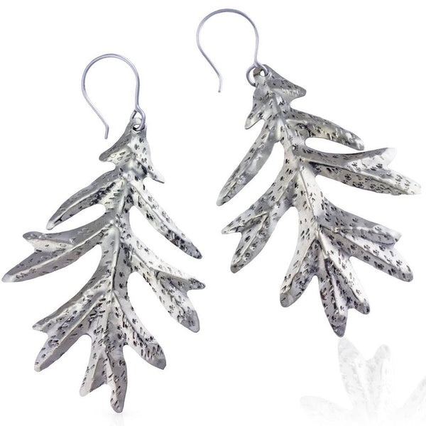 alpaca oak leaf earrings on white background